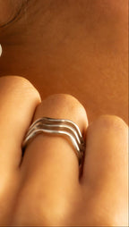 Close-up of a silver triple wavy ring 