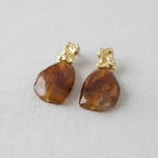 Pair of brown marbled stone earrings with gold nugget on a light gray background