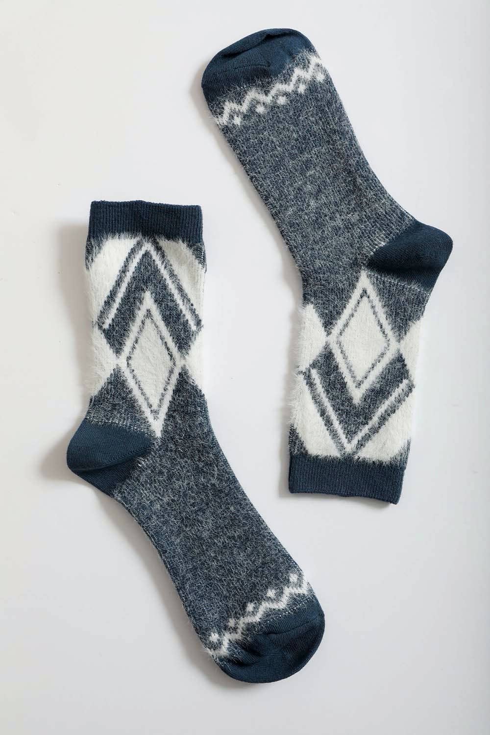 Pair of blue diamond pattern faux mohair socks on a light gray background