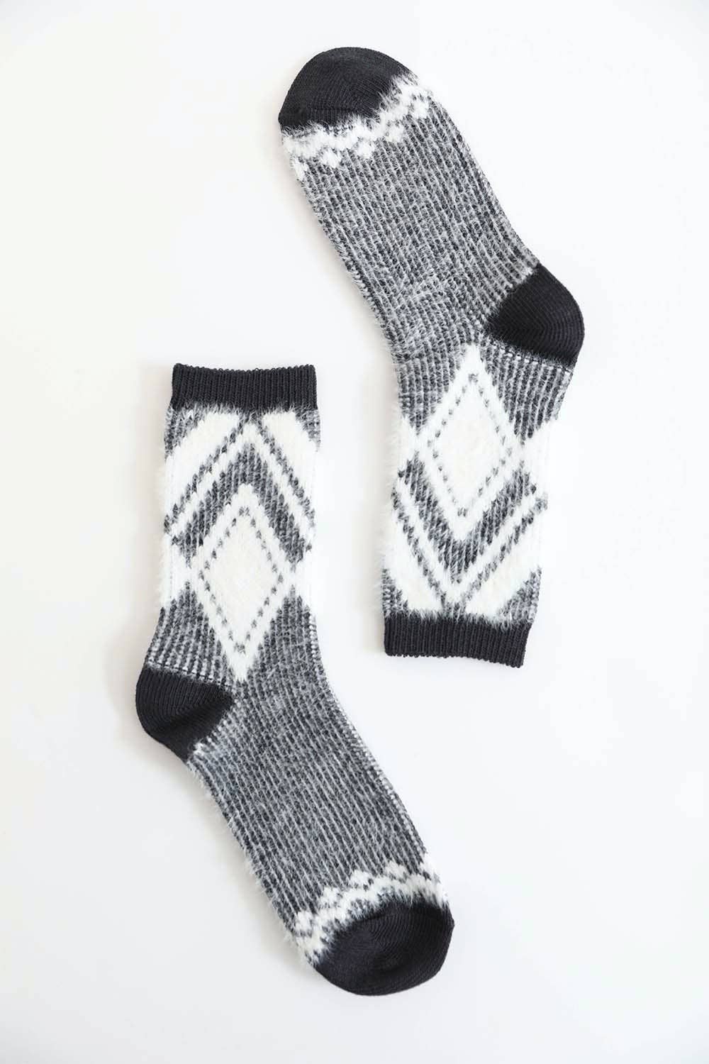 Pair of black diamond pattern faux mohair socks on a white background