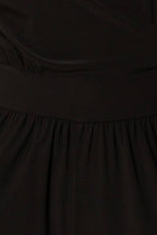 Close-up of a black fabric with a focus on the waistband and fabric texture.