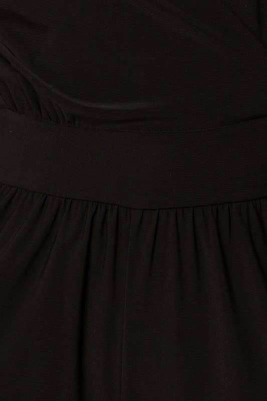 Close-up of a black fabric with a focus on the waistband and fabric texture.