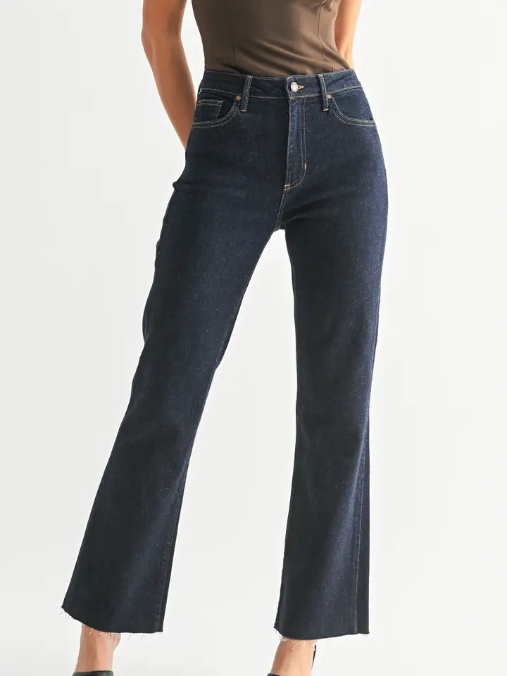 Flare leg jeans in premium dark wash worn by a person on a white background