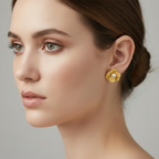 Close-up of a woman wearing yellow earrings with a gray background