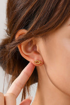 Woman wearing 18k gold-plated stainless steel knot earrings