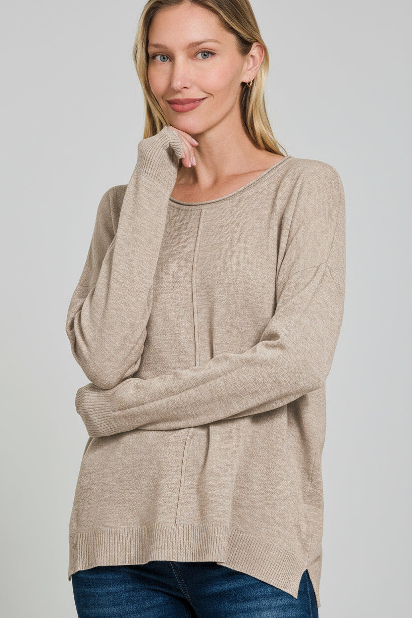 Woman wearing an ash mocha front seam sweater with a white background