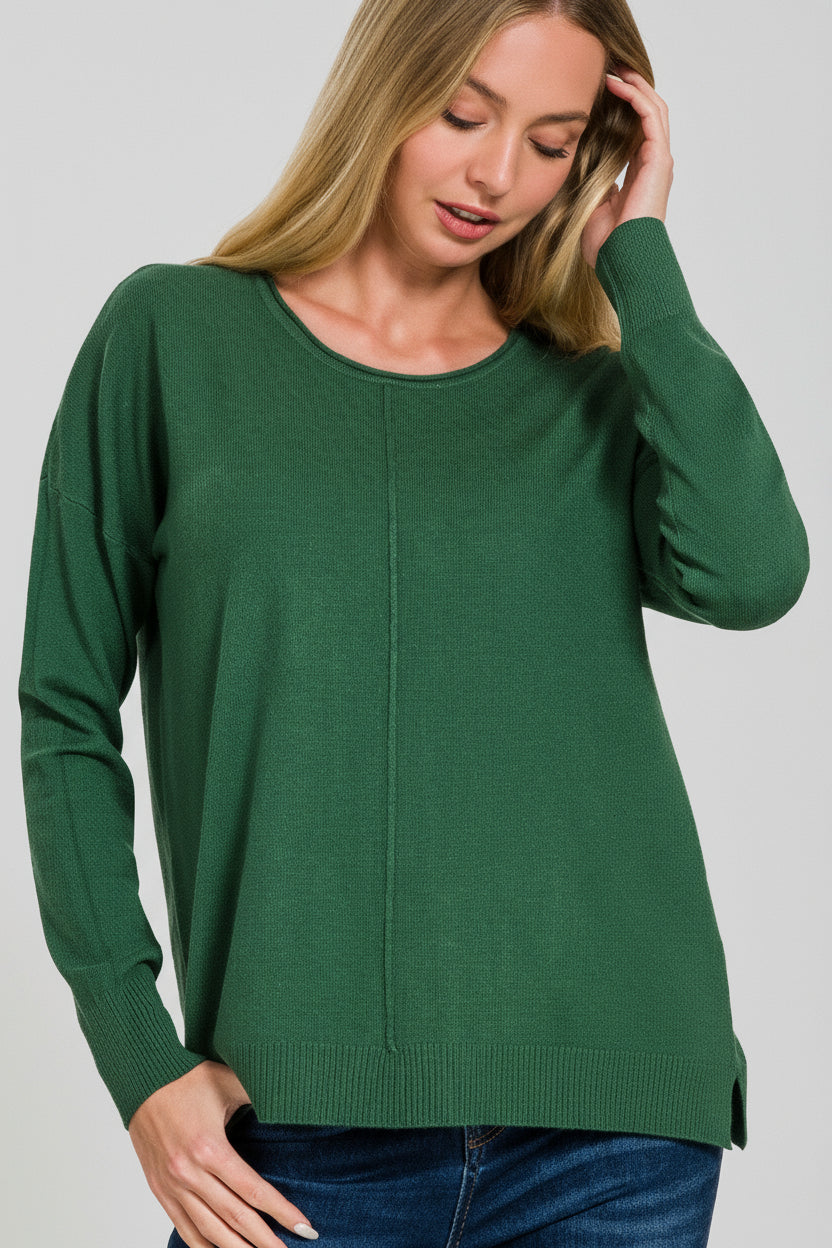 Woman wearing a dark green front seam sweater on a white background
