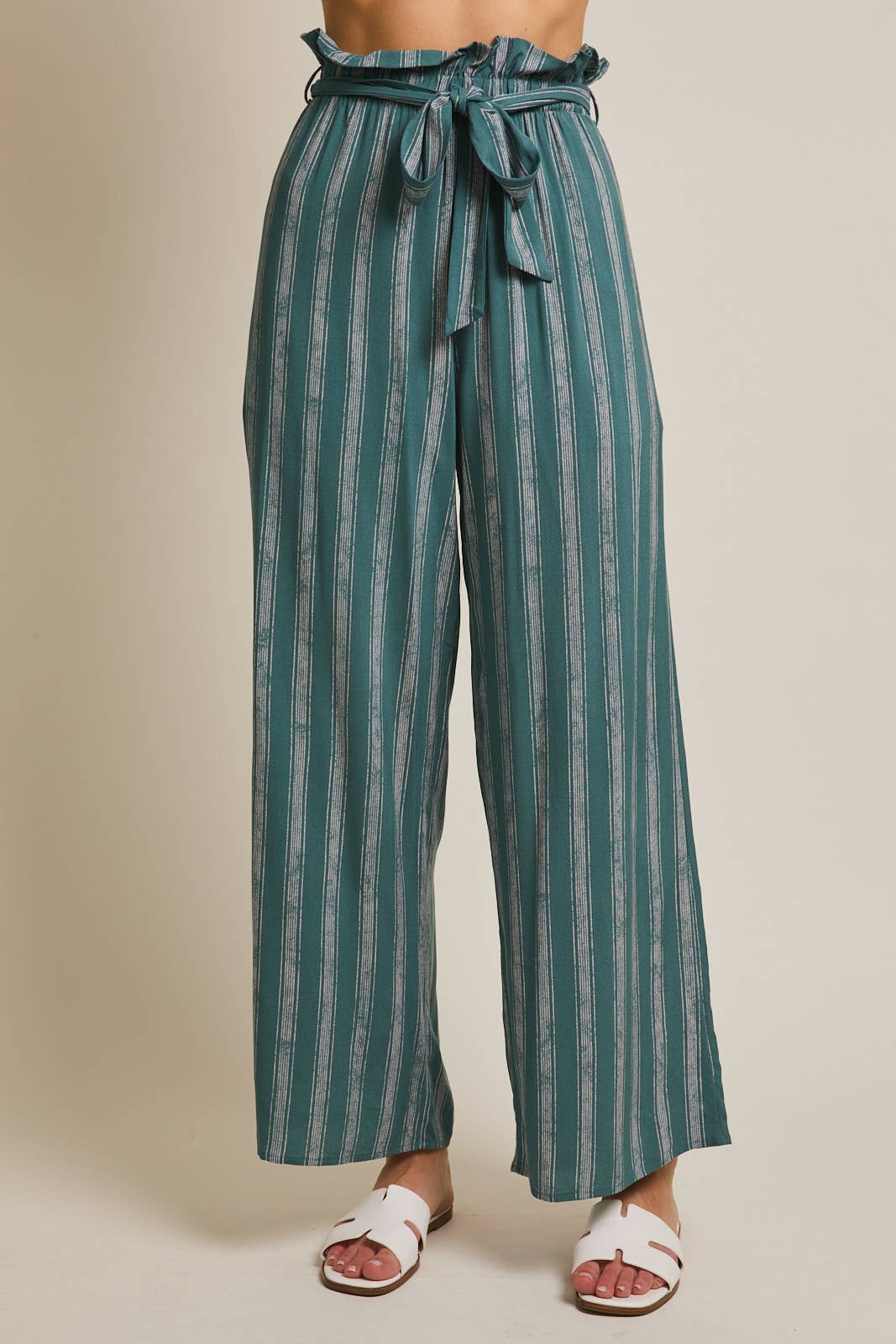 Woman wearing striped green and cream ruffle top pants with self tie