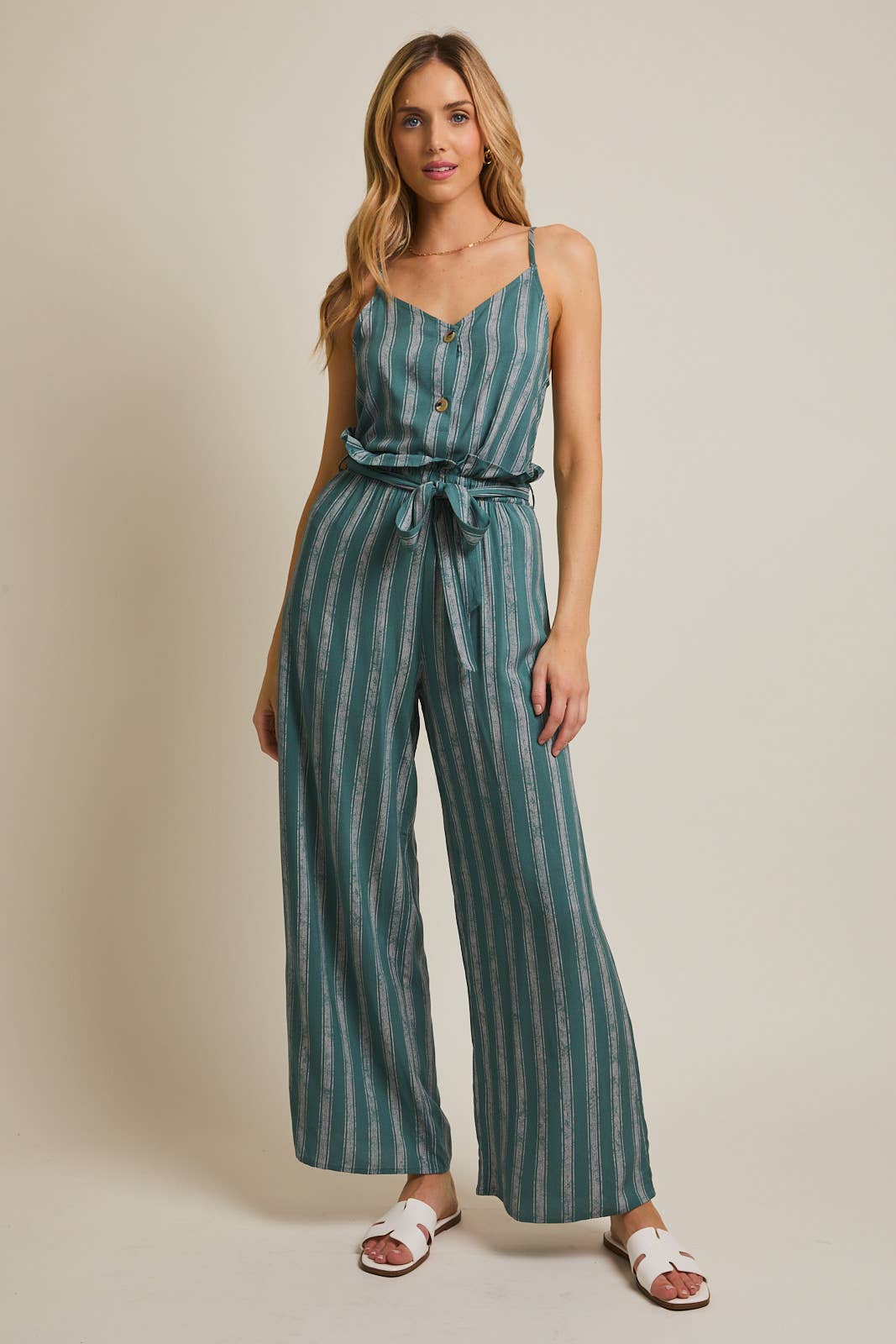 Woman wearing striped green and cream ruffle top pants with self tie