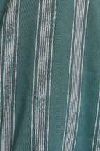 Close up of green and cream striped ruffle top pants. 