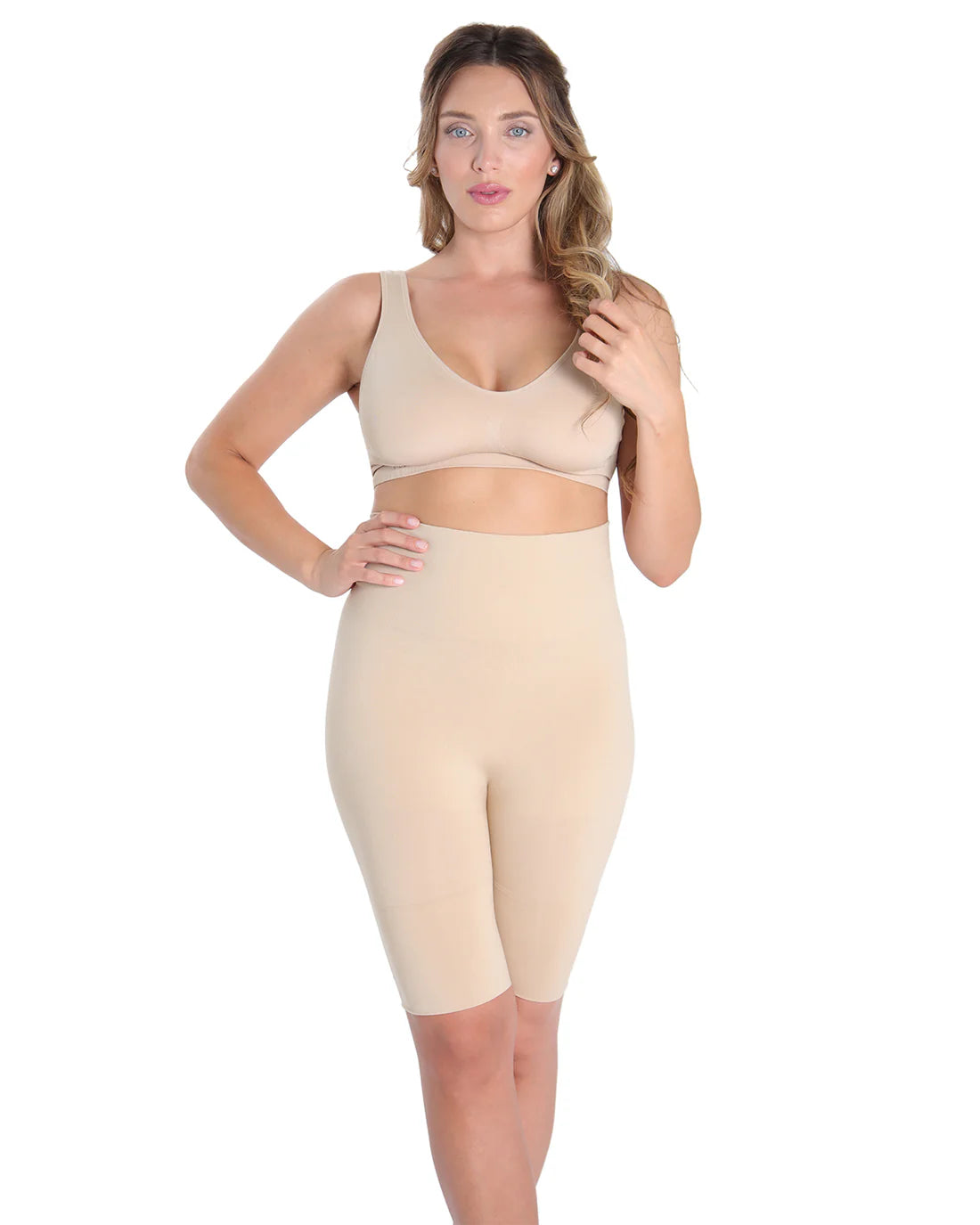 Woman wearing a nude high waist thight shaper on a white background