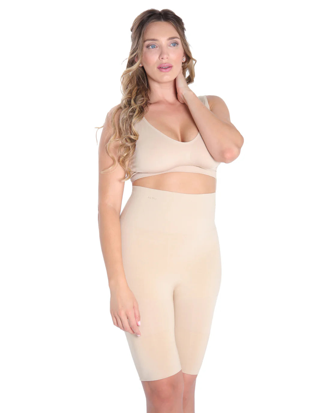Woman wearing a nude high waist thight shaper on a white background