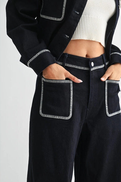 Women's dark denim with white stitching on a plain background