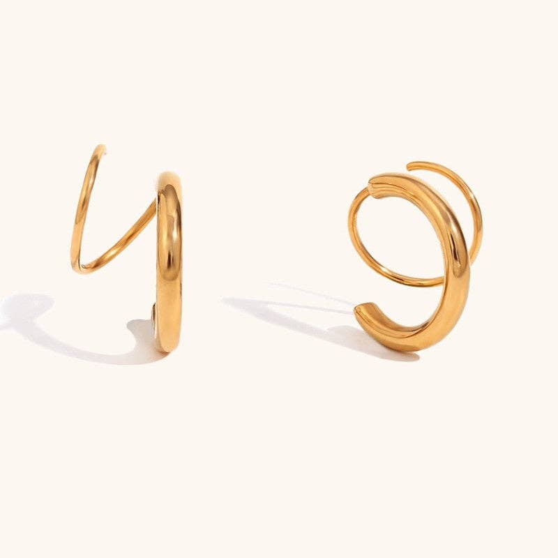A pair of 18k gold-plated spiral hoop earrings shown on a clean, solid off-white background.