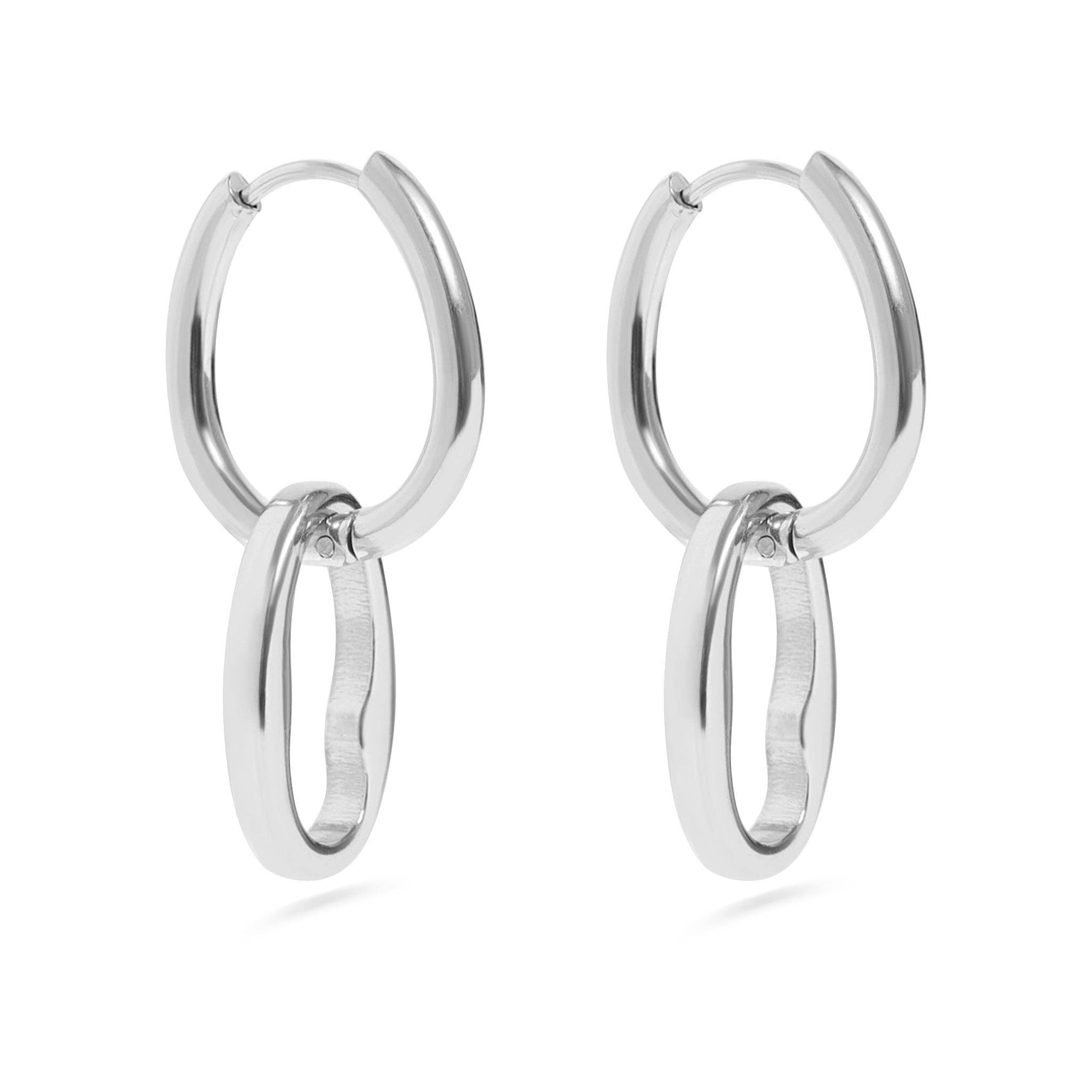 Pair of silver interlocking oval hoop earrings on a white background