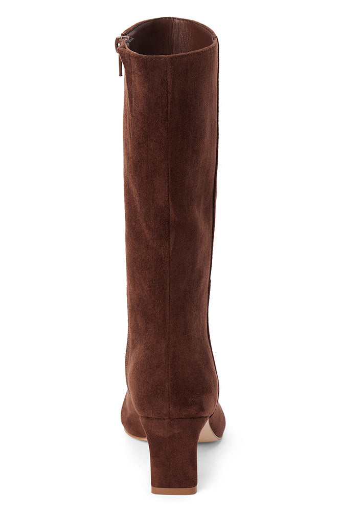 A slim kitten heel mid-calf brown suede boot shown from a back profile on a white background.