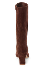 A slim kitten heel mid-calf brown suede boot shown from a back profile on a white background.