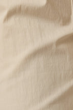 Close up of ecru twill pants