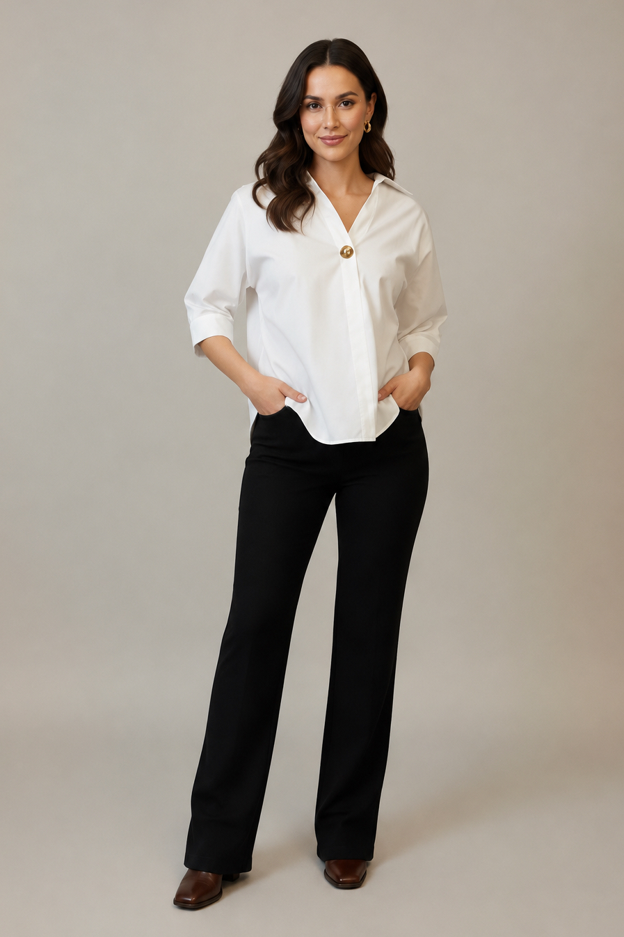 A woman modeling an off white button detail shirt with rolled-up sleeves, paired with black pants set against a plain light gray background.
