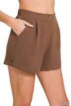 Woman wearing brown shorts on a white background