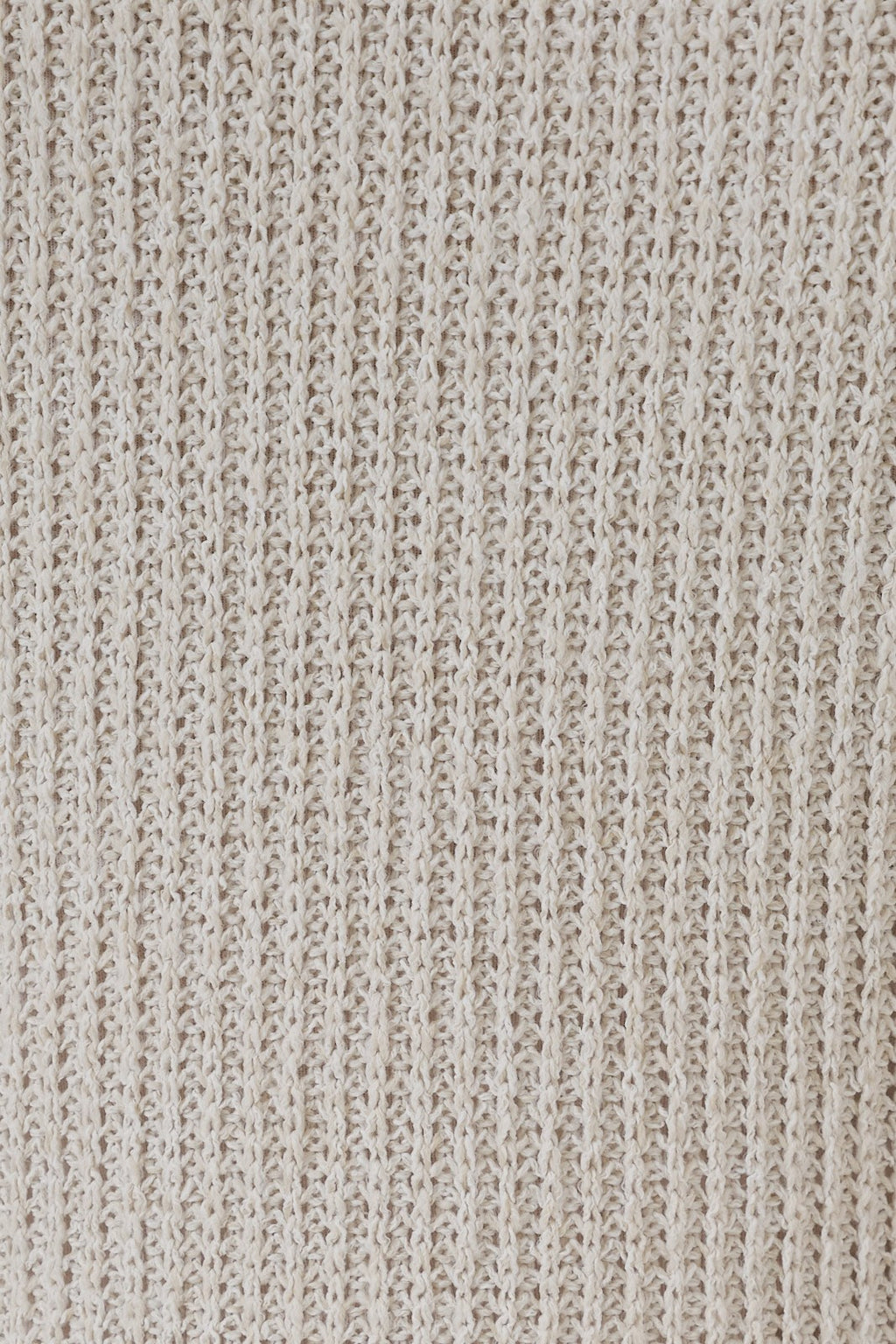 Close-up of natural tone boucle showing the detailed texture.