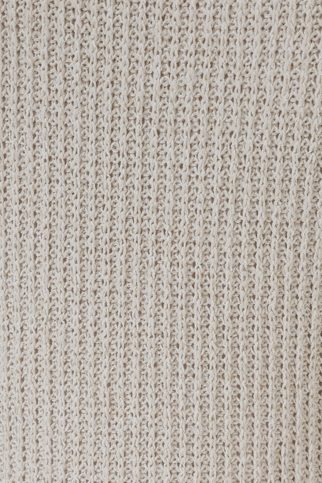 Close-up of natural tone boucle showing the detailed texture.