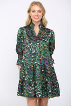 Woman wearing a green background  patterned dress on a white background