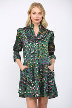 Woman wearing a green background  patterned dress on a white background