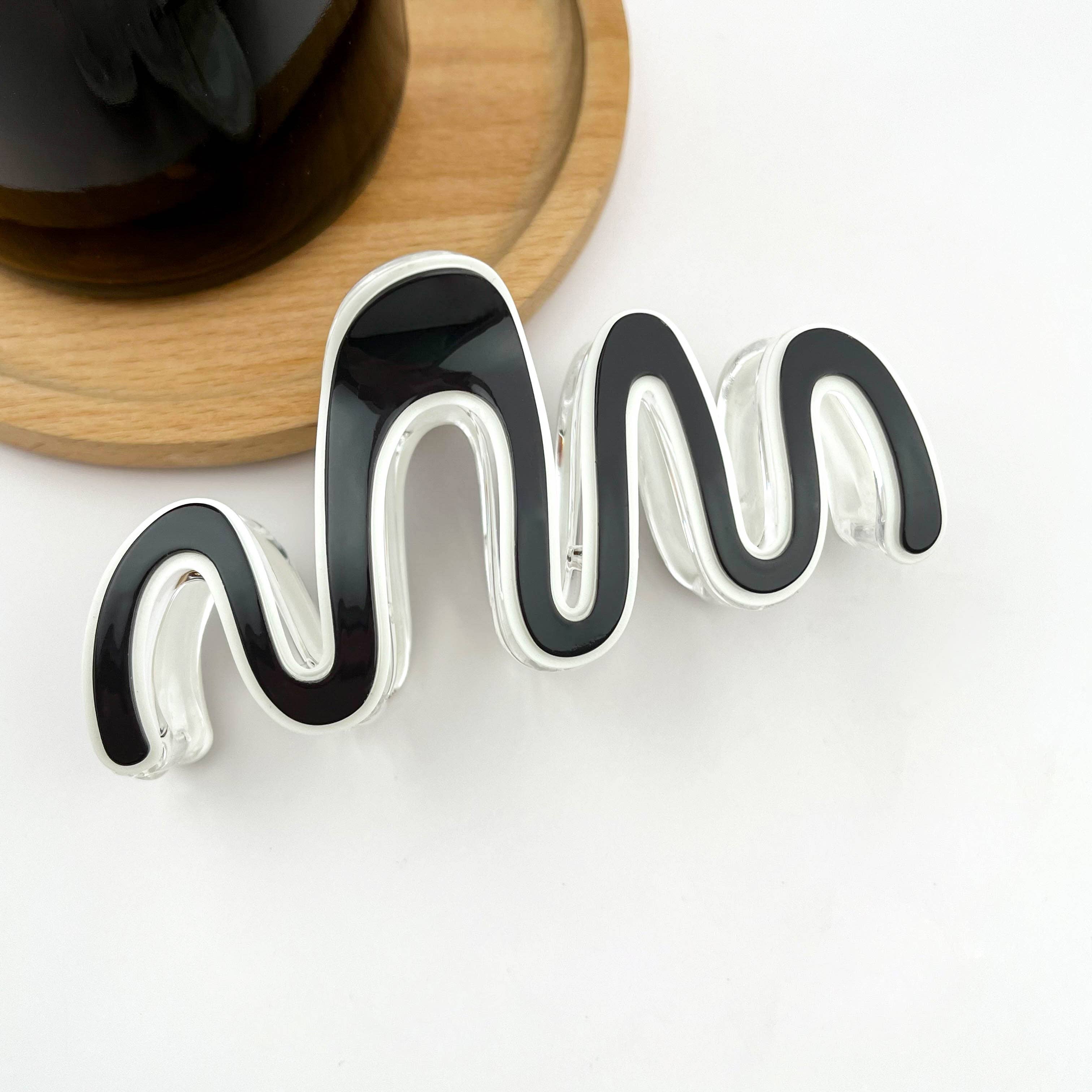 Black and white large wave claw clip on a white background