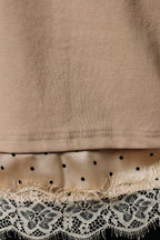 Close-up of a taupe knit garment with lace and satin trim at the bottom.
