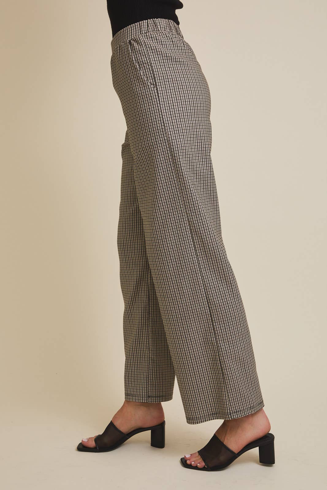 Checkered pants worn by a person on a beige background