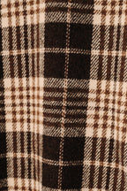 A close-up of a plaid fabric pattern with alternating vertical stripes in brown and cream.
