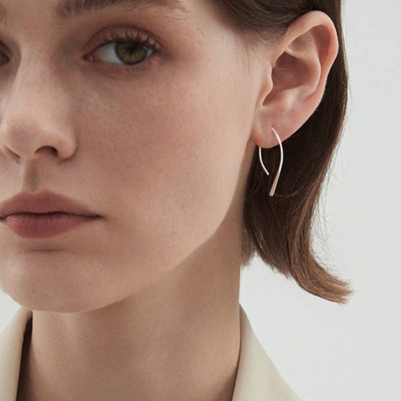 Woman wearing silver plated open arch threader earrings 