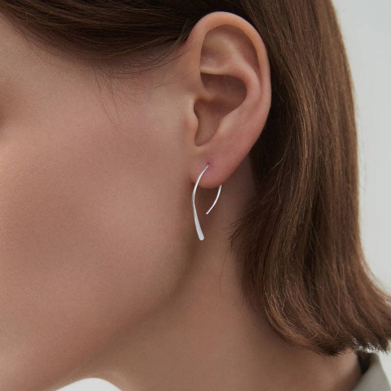 Woman wearing silver plated open arch threader earrings 