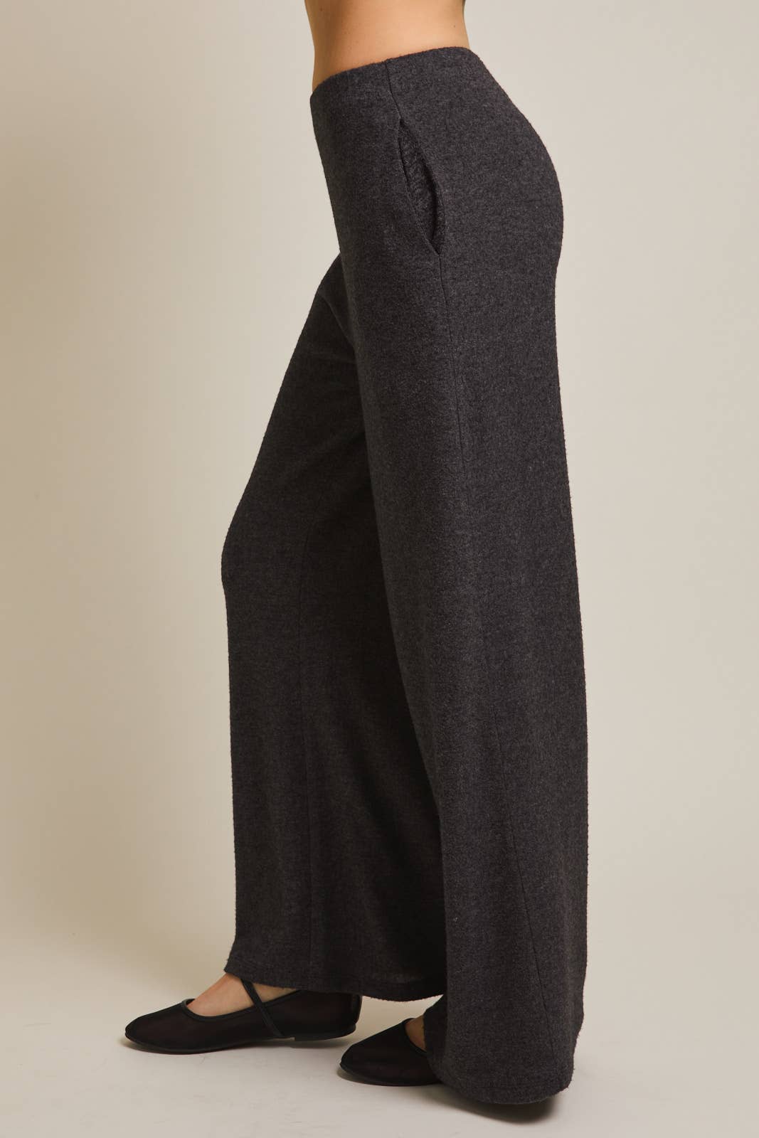 Heather gray wide-leg pants worn by a person on a beige background