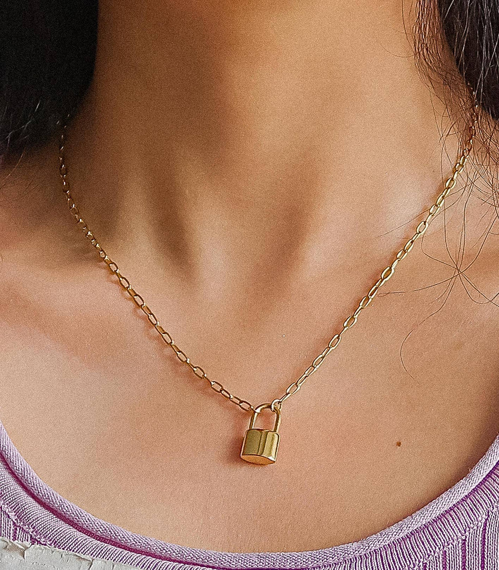 Woman wearing a lock pendant chain necklace 