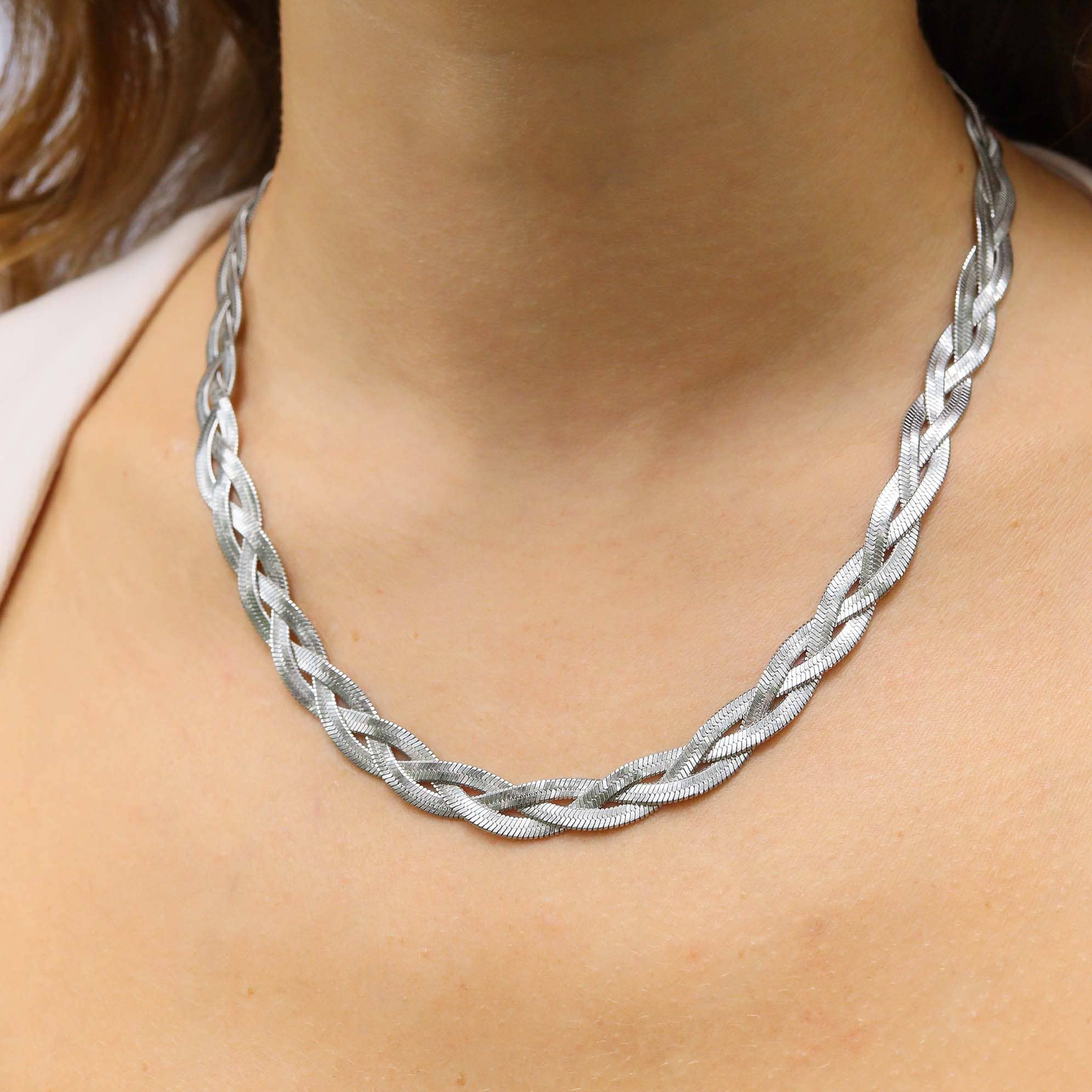 Woman wearing a silver interwoven herringbone necklace