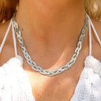 Woman wearing a silver interwoven herringbone necklace