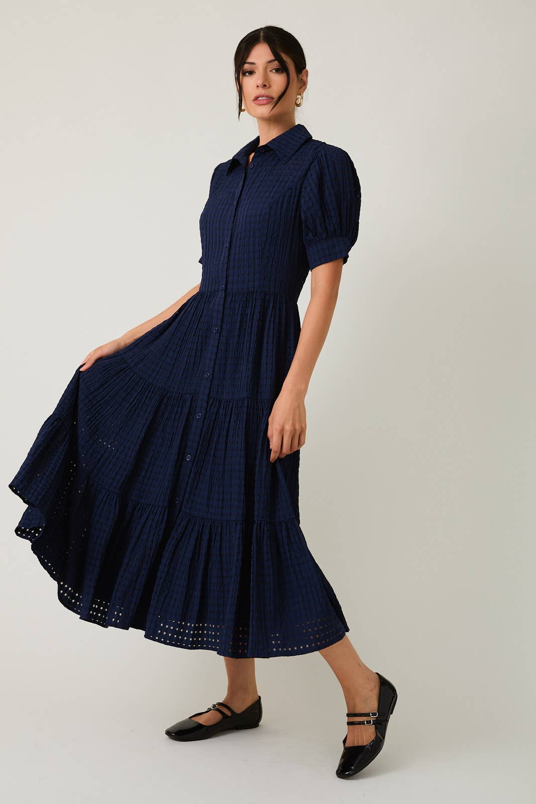 Women's navy flowy tiered midi dress with collar and button front