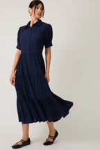 Women's navy flowy tiered midi dress with collar and button front