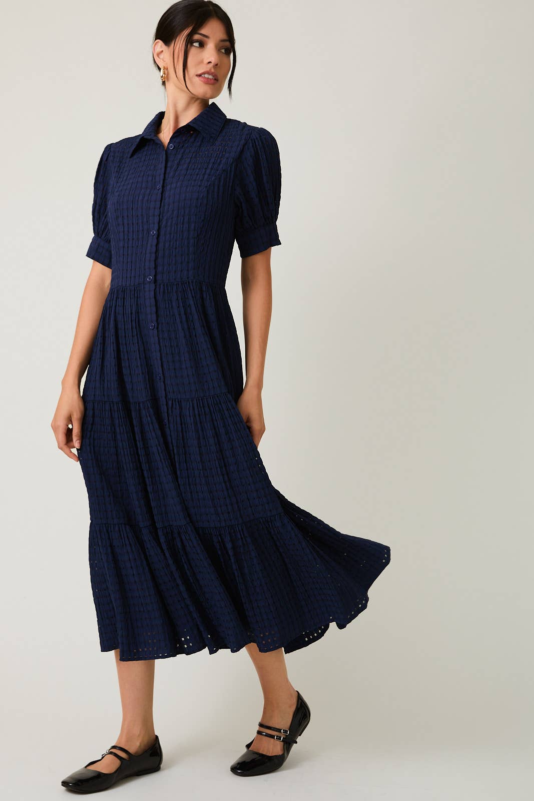Women's navy flowy tiered midi dress with collar and button front