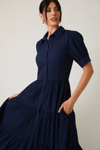 Women's navy flowy tiered midi dress with collar and button front