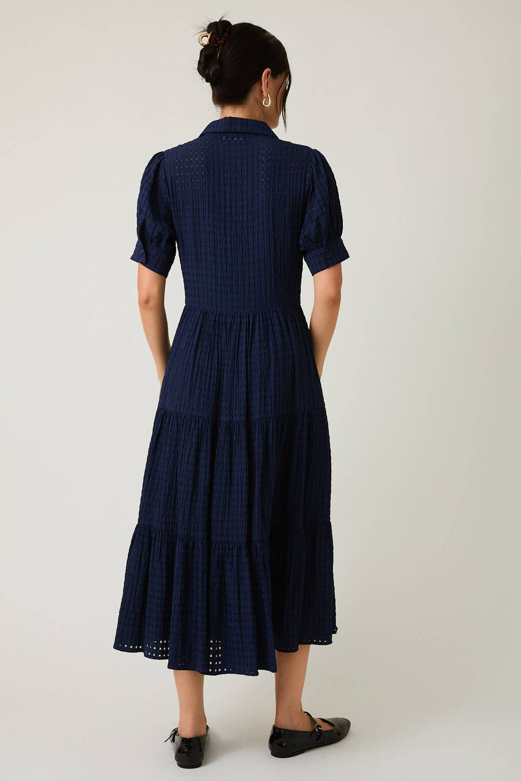 Women's navy flowy tiered midi dress with collar and button front