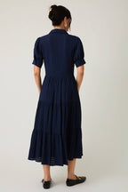 Women's navy flowy tiered midi dress with collar and button front