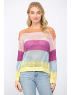 Woman wearing an open weave color block striped sweater on a white background