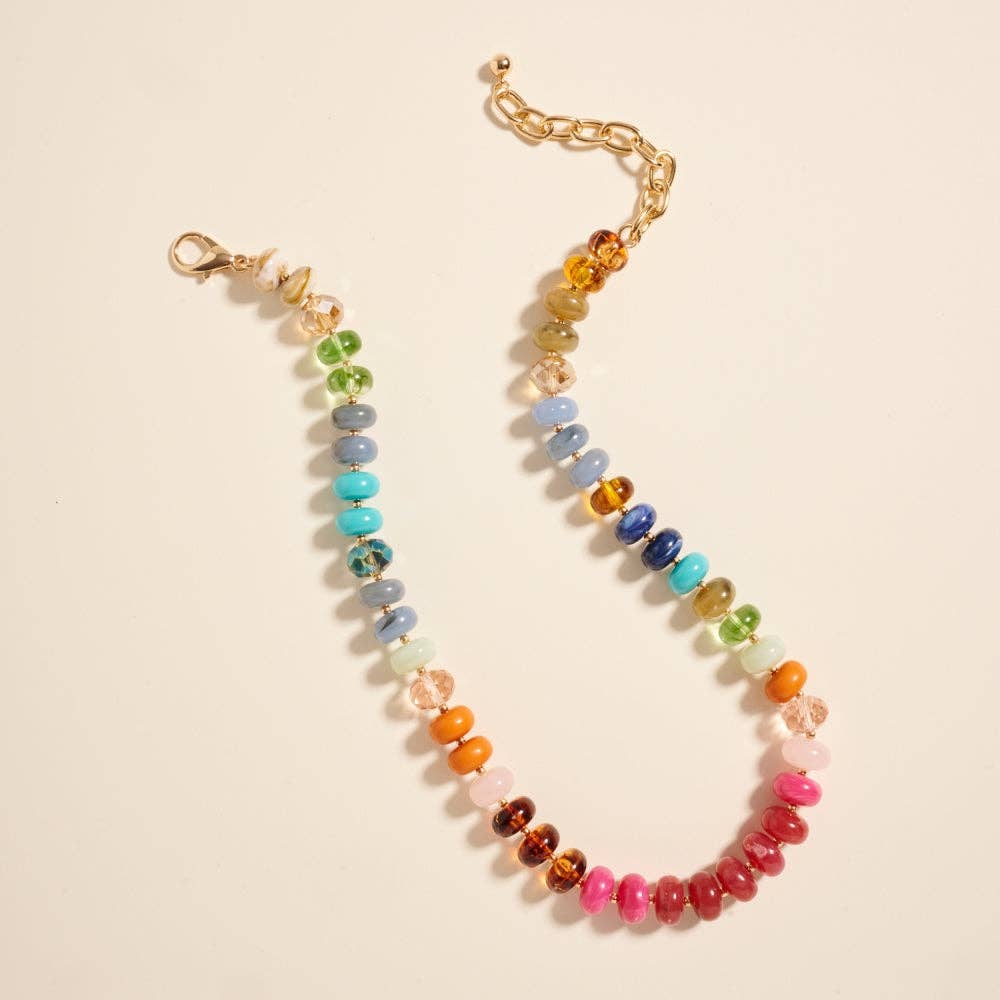 Multicolored beaded necklace on a beige background