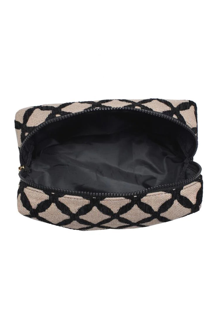 Open black diamond pattern on tan fabric cosmetic bag with black lining on white background
