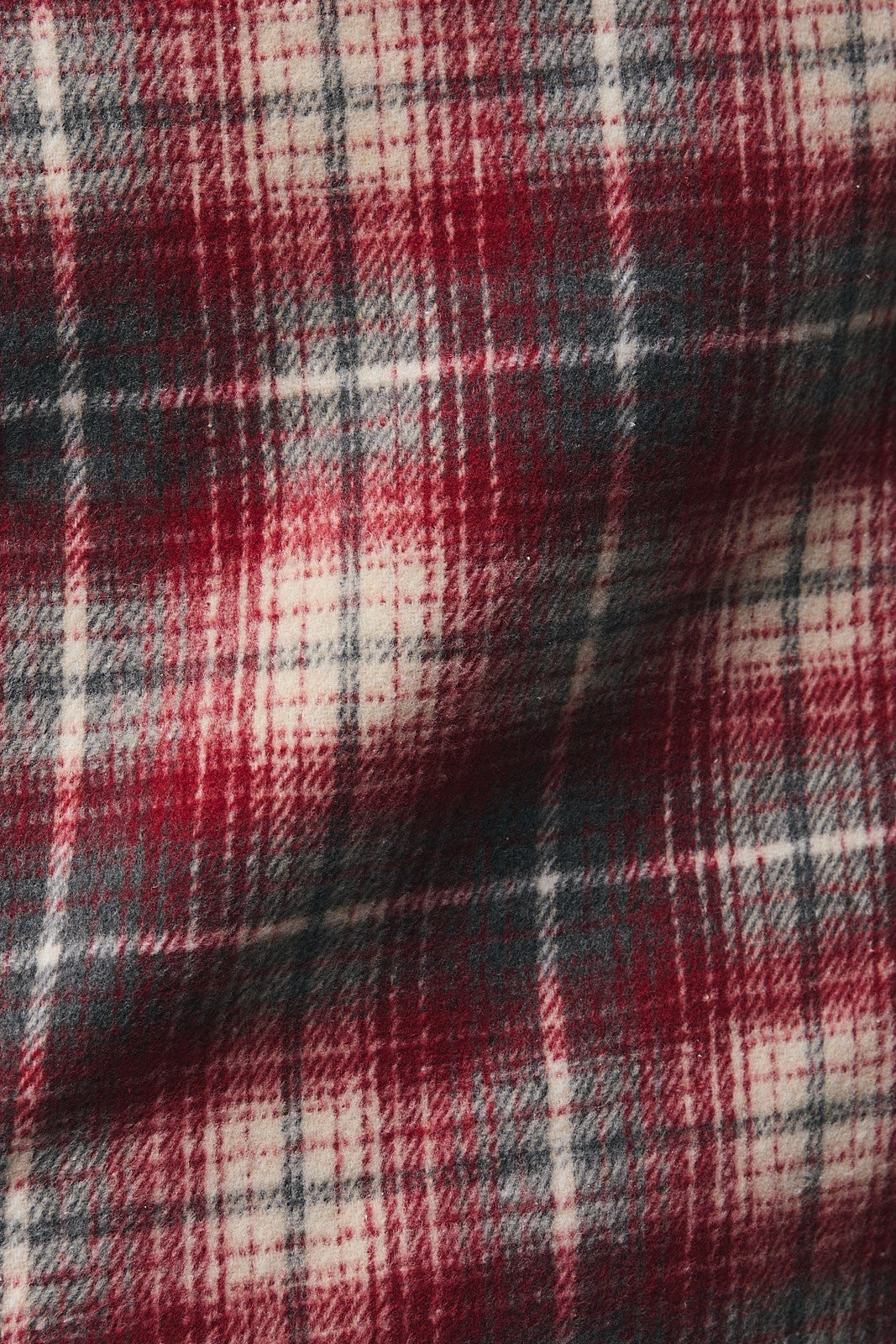 Close-up of red, grey, and cream plaid fabric