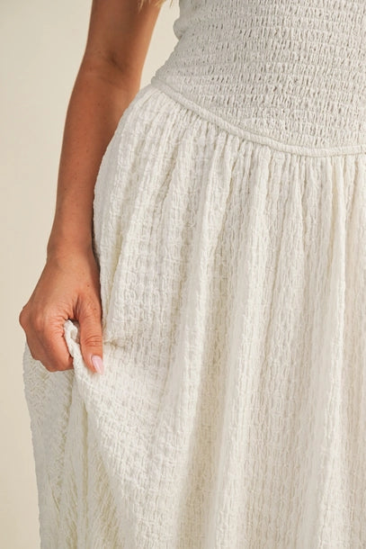 Close of the off white bubble texture maxi dress fabric