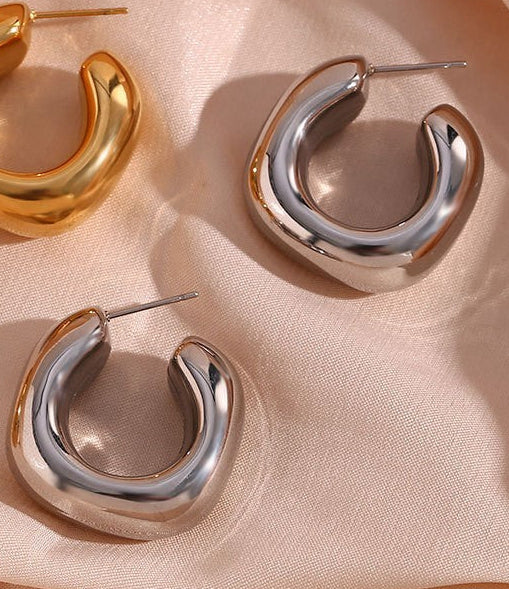 Pair of 18k silver-plated stainless steel bubble hoop earrings on a white background